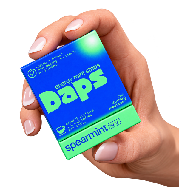 Hand holding Daps spearmint energy mint strips